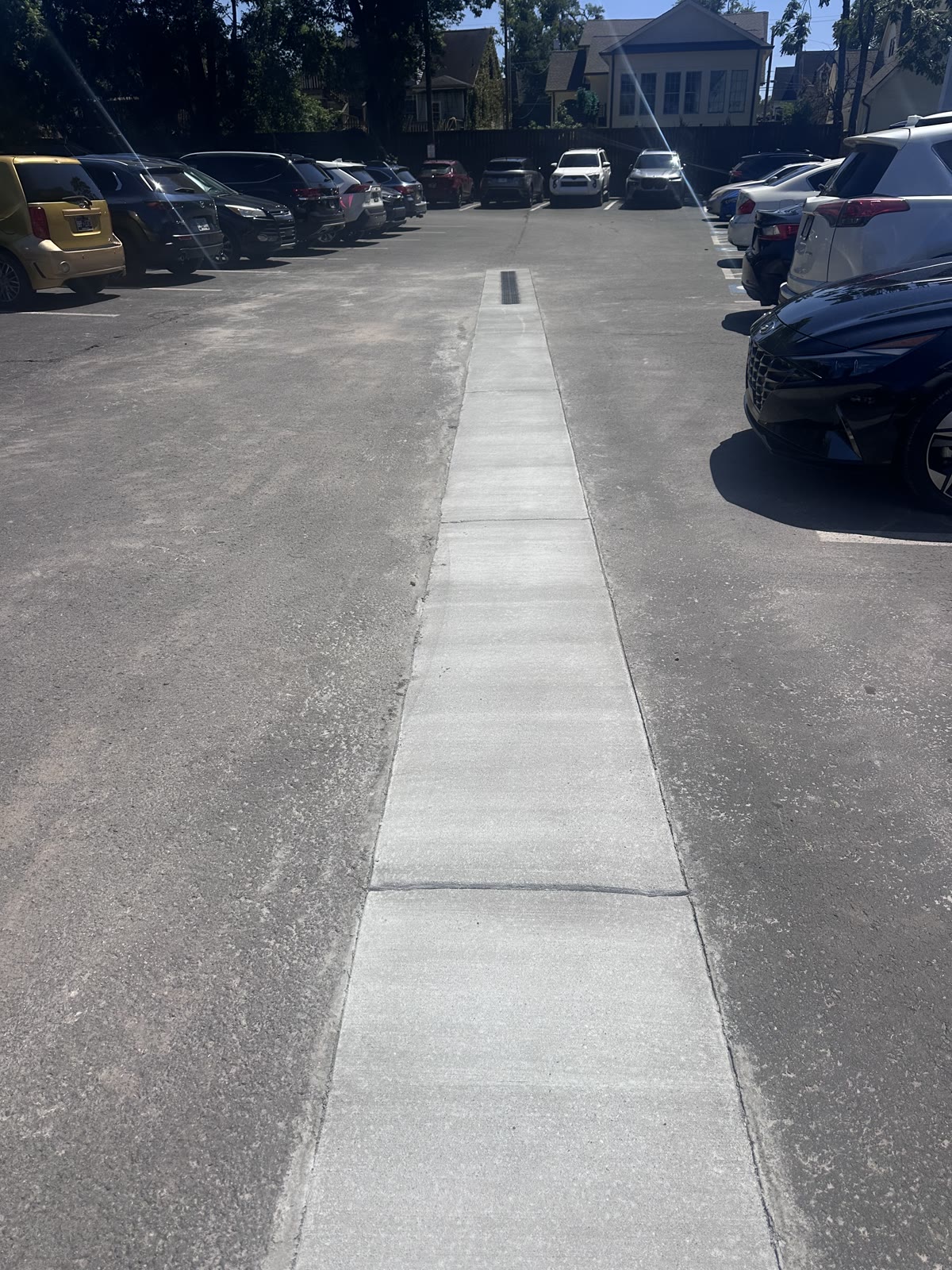 Completed concrete drainage channel through a Nashville commercial parking lot