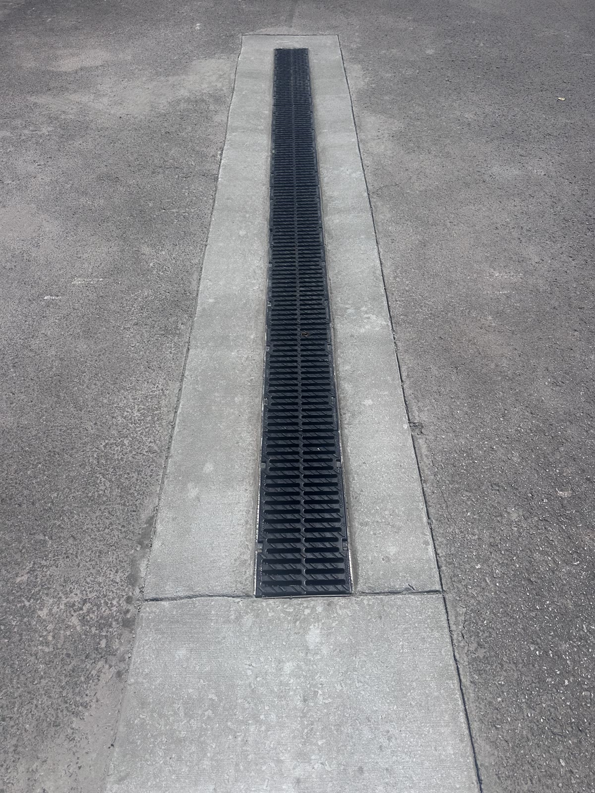 Heavy-duty trench drain installed in a commercial parking lot