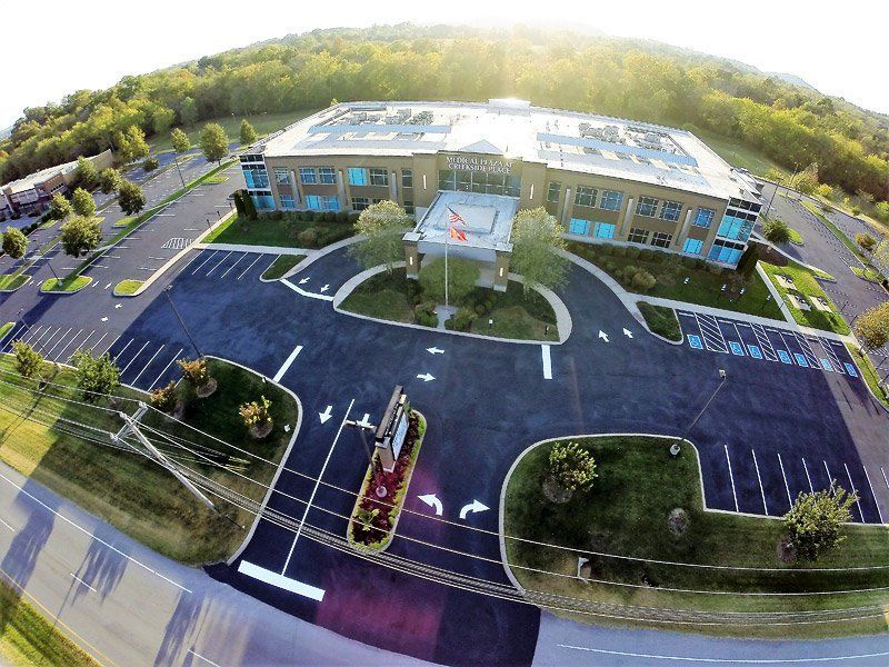 Aerial view of a freshly paved and striped commercial parking lot