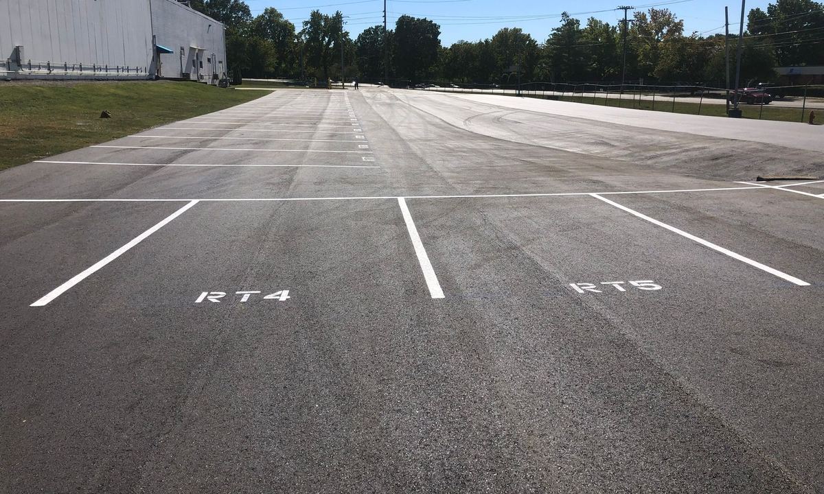 Repaved delivery truck parking area with new route-number striping