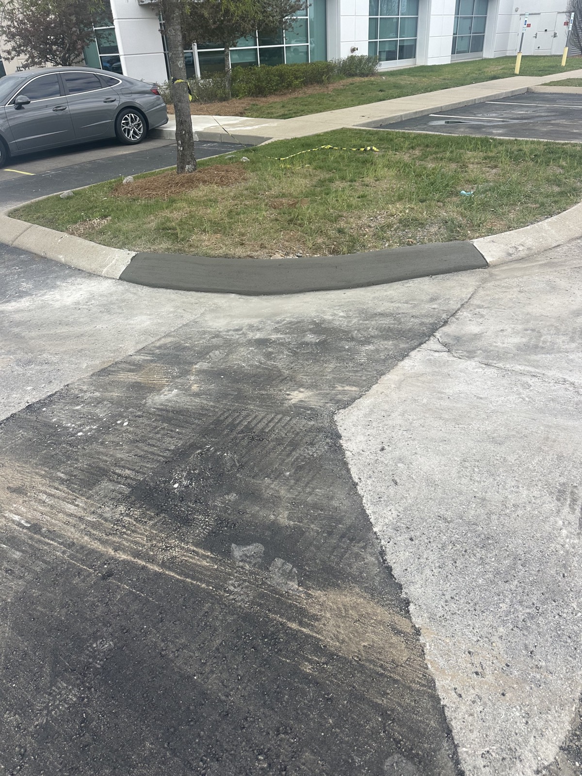 A failed section of asphalt cut out and squared up before a full-depth repair
