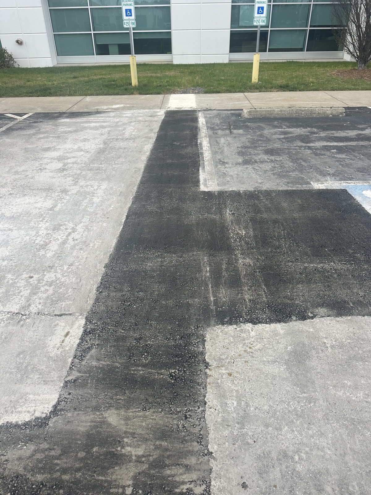 A milled section of a commercial parking lot prepared for a full-depth asphalt repair