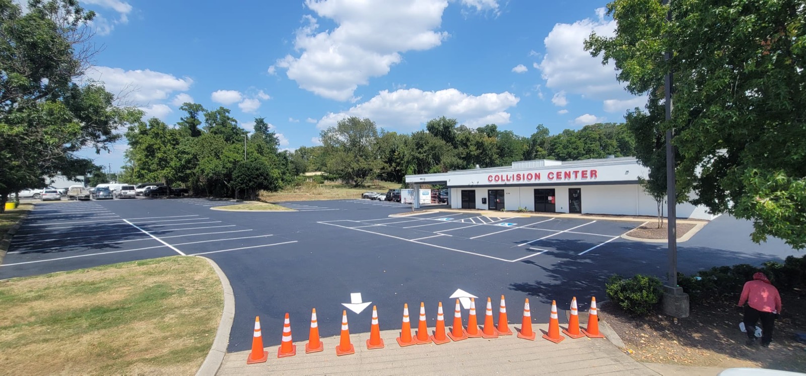 A commercial lot immediately after sealcoating and restriping, with fresh black surface and crisp white stall lines