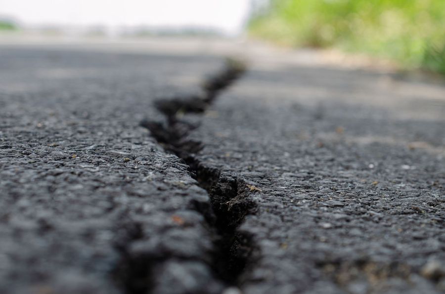 Crack in asphalt pavement before hot crack fill treatment