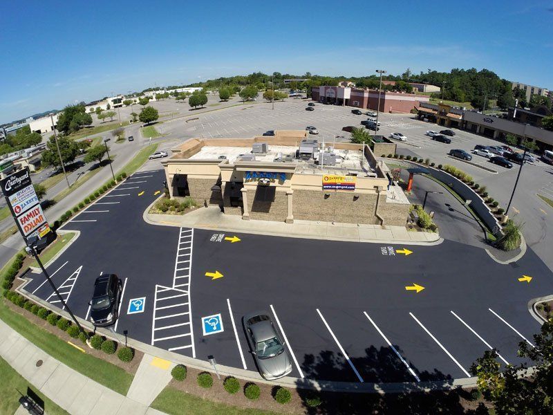 Aerial view of retail center parking lot with new striping