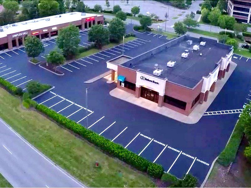 Aerial view of a freshly sealed and striped commercial lot