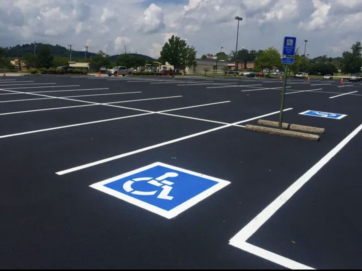 New accessible parking stall marking on fresh sealcoat